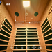 Infrared sauna interior with wooden panels, LED light, and sound system controls.