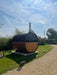 GARDEN HOUSE 24 Barrel Sauna LEO with Half Moon Glass 2 x 1.6 m Bespoke front view in garden
